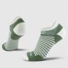 The Amelia No Show Tab Lightweight Socks in Sparrow Green by Woolx are displayed with one sock upright showing the heel, and the other slightly tilted to highlight the toe and sole. These moisture-wicking socks have cushioned heels and toes, ensuring your feet stay dry and comfortable all day long.