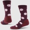 A pair of maroon Dotalicious Light Cushion Crew Socks by Woolx, featuring the Wild Ginger Dot pattern with large pink polka dots, are displayed upright. They are shown in both front and side views against a plain white background. These stylish socks also boast odor-resistant properties for lasting freshness.