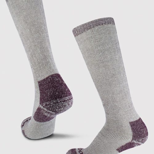 The Woolx Extreme Full Cushion Over The Calf Socks in Windsor Wine feature a heavyweight merino wool construction with purple accents at the toes, heels, and cuffs. They stand upright against a plain white background, with one sock slightly higher than the other to highlight their texture and design.