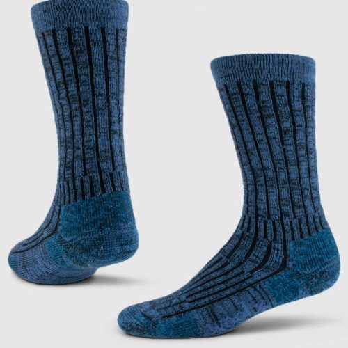 Introducing the Joey Full Cushion Mid Calf Socks from Woolx in Steel Blue. These socks feature black vertical stripes and a textured pattern, crafted from soft merino wool. They are presented against a light gray backdrop, standing upright to highlight their full length and design.