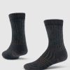 Two Joey Crew Socks by Woolx in Dark Expresso are showcased against a light background, one standing upright and the other angled to the side, featuring a ribbed design with brown vertical stripes.