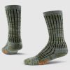 A pair of Joey Full Cushion Mid Calf Socks in Dark Forest Marled from Woolx, featuring black vertical stripes and musical note patterns. Crafted from Merino wool for added warmth, they showcase an orange logo on the toe against a plain white background.