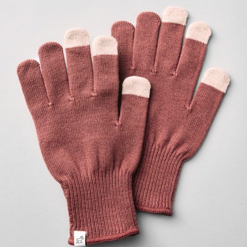 A pair of Asher Tech Gloves - Wild Ginger by Woolx, featuring a brown knit design with cream-colored fingertips, is laid flat on a light gray surface. A small tag is attached to one glove.