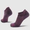 Two Rowan No Show Tab Lightweight Socks from Woolx in Wild Ginger are displayed against a white background. Made from breathable Merino wool, they feature ribbed cuffs and a textured pattern on the heel and toe area, providing both comfort and durability.