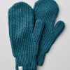 A pair of Holly Mittens by Woolx, in a rich Real Teal color, crafted from soft Merino wool, rests elegantly on a light gray surface. The mittens feature a ribbed texture and are adorned with a small tag showing a simple line drawing at the cuff of one mitten, highlighting their design as sophisticated women's winter gloves.