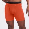 A person wearing the Reaction Boxer Briefs in Summer Fig by Woolx, with an orange design complemented by a black waistband that has "woolx" written on it. The image emphasizes the midsection and upper legs against a simple background, highlighting the ultra-durable fabric for extended wear and ultimate comfort.