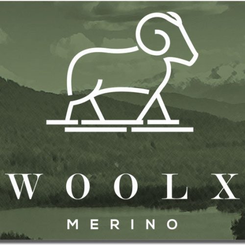 The Woolx Gift Card showcases a stylized outline of a ram set against a green background adorned with subtle mountain and forest imagery. "GIFT CARD" is printed on the left side, while the bottom features "WOOLX MERINO"—an excellent choice for your next shopping spree.