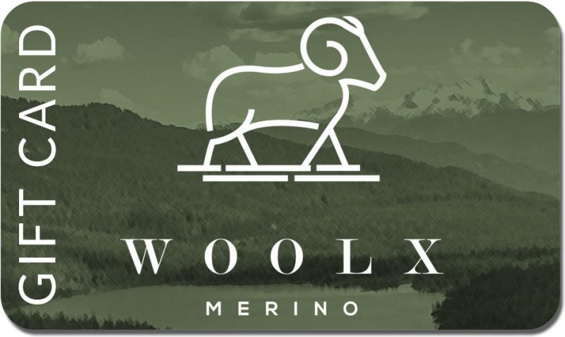 The Woolx Gift Card showcases a stylized outline of a ram set against a green background adorned with subtle mountain and forest imagery. "GIFT CARD" is printed on the left side, while the bottom features "WOOLX MERINO"—an excellent choice for your next shopping spree.