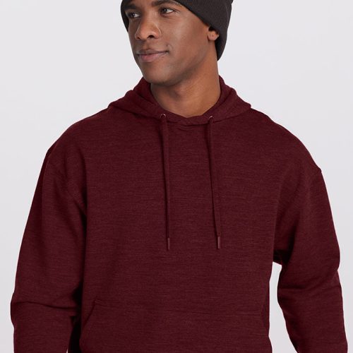 A person is wearing a Chase Hoodie - Cranberry Melange from Woolx and a dark gray beanie with a square brown patch on the front. They are looking off to the side against a plain, light-colored background. | Trell is 6’2”, wearing a size M