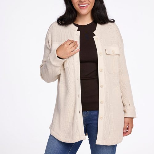 A woman with long dark hair smiles while wearing the Oaklynn Waffle Shacket in oatmeal from Woolx over a black top and blue jeans. She stands against a plain white background. | Sarah is 5'8", wearing a size S