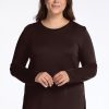 A woman dressed in the Blair Tunic by Woolx, made from odor-resistant merino wool in a French Roast color. | Juliana is 5'10", wearing a size XL