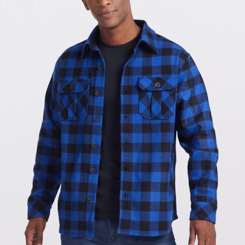 A person in a Woolx Burlington Jacket - Bright Blue Black over a black t-shirt, paired with ultra-heavyweight blue jeans, stands against a plain white background. | Trell is 6’2”, wearing a size M