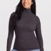 A person with long black hair smiles while wearing the Woolx Sage Ribbed Turtleneck in Pebble Grey Melange and stretchy light blue jeans, standing against a plain white background. | Denia is 5'8", wearing a size S