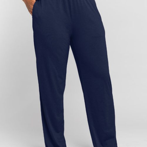 A person wearing the Woolx Maya Lounge Pants in Starry Night, featuring a white waistband, standing barefoot against a plain light gray background. The moisture-wicking lounge pants have a relaxed fit, with the person's left hand in the pocket. | Tori is 5'7", wearing a size S