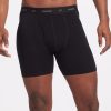 The image features an individual wearing the Reaction Boxer Briefs in Black, showcasing the Woolx brand name on the waistband. The front view highlights the comfortable fit of these performance boxers on the torso and upper legs.