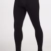 A person wearing Woolx's Backcountry Leggings in black, with "Woolx" branded on the waistband. These form-fitting Merino base layer bottoms extend down to the ankles and are ideal for cold weather adventures, featuring luxurious Australian Merino Wool. The person is standing barefoot on a plain white background. | Terrence is 6'3", wearing a size L