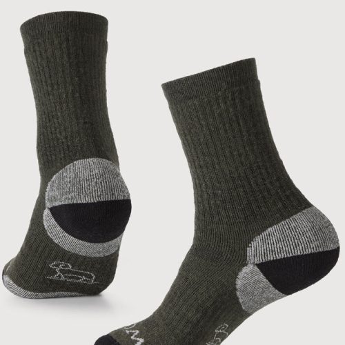 Displayed are two Core Crew Socks Full Cushion in the "Deep Forest" color by Woolx. One sock highlights the heel and sole design, made from Merino wool for premium comfort, while the other showcases its front and top. Positioned at an angle, they emphasize their moisture-wicking properties and texture.