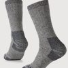 A pair of Extreme Full Cushion Crew Socks in Charcoal Heather by Woolx is displayed against a plain white background. These socks look thick and warm, providing exceptional warmth, making them ideal for cold weather.