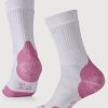 Introducing the Milo Full Cushion Cold Weather Socks by Woolx in Pebble Pink. These socks feature a white base with Pebble Pink highlights on the heel and toe, made from moisture-wicking Merino wool. Displayed upright, they highlight their ribbed texture and striking color contrast.