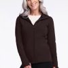 A smiling woman with long white hair is wearing a Woolx Zoey Zip Up Hoodie in French Roast over a white shirt. Perfect for layering, the zip-up hoodie is made from luxurious Australian Merino Wool. She is standing against a plain white background. | Tam is 5'8.5", wearing a size S